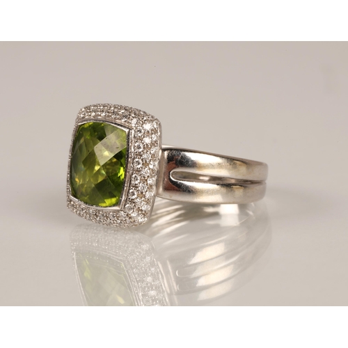 65 - Ladies peridot and diamond ring, central square cut peridot surrounded by three rows of small diamon... 