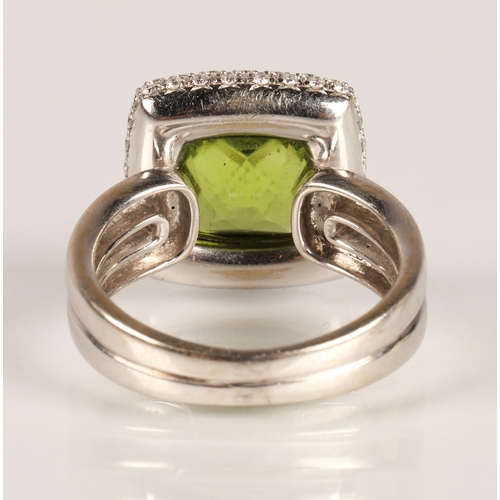65 - Ladies peridot and diamond ring, central square cut peridot surrounded by three rows of small diamon... 