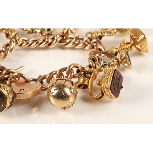 71 - Gold hollow curb link charm bracelet with seventeen assorted charms to include 9ct gold masonic ball... 