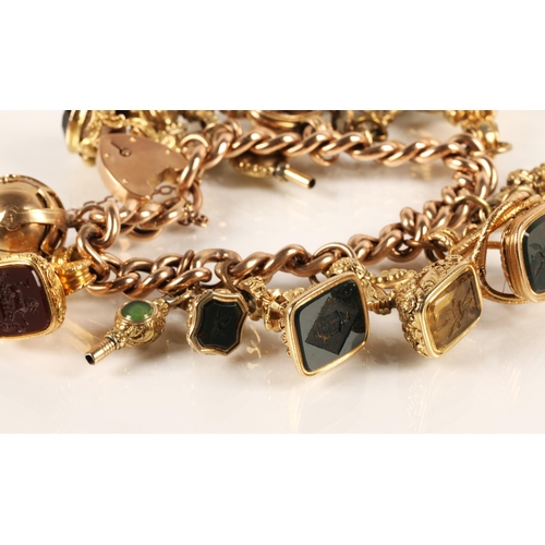 71 - Gold hollow curb link charm bracelet with seventeen assorted charms to include 9ct gold masonic ball... 