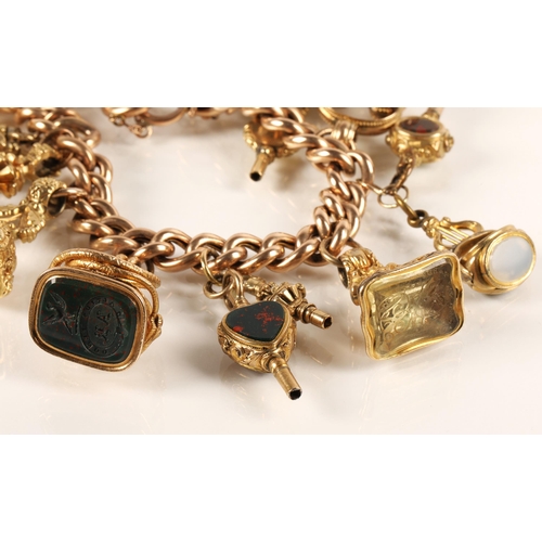 71 - Gold hollow curb link charm bracelet with seventeen assorted charms to include 9ct gold masonic ball... 