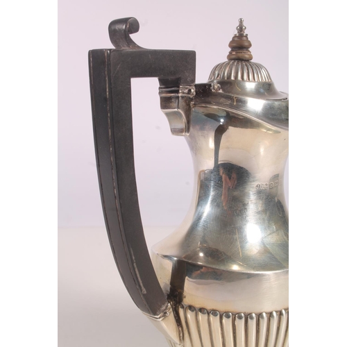 19 - Geo. V silver water pot, of baluster form with ebonised angular handle and half lobed body, Joseph G... 