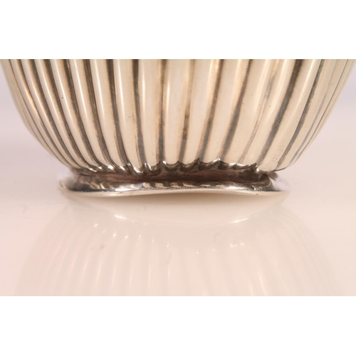 19 - Geo. V silver water pot, of baluster form with ebonised angular handle and half lobed body, Joseph G... 