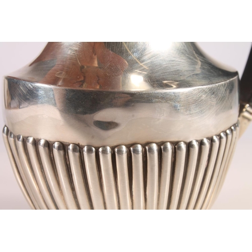 19 - Geo. V silver water pot, of baluster form with ebonised angular handle and half lobed body, Joseph G... 