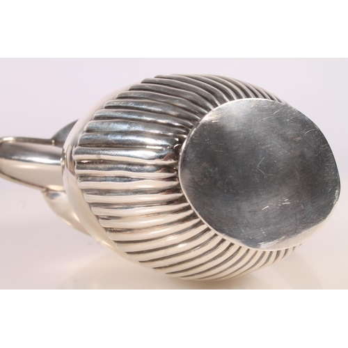 19 - Geo. V silver water pot, of baluster form with ebonised angular handle and half lobed body, Joseph G... 