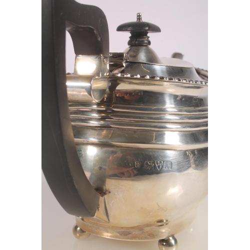 20 - Geo. V silver three piece tea set, the teapot with scrolled ebonised handle, gadrooned rim over a st... 