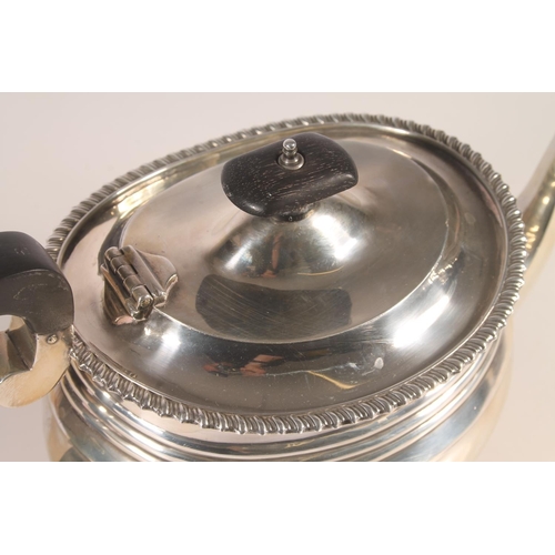20 - Geo. V silver three piece tea set, the teapot with scrolled ebonised handle, gadrooned rim over a st... 