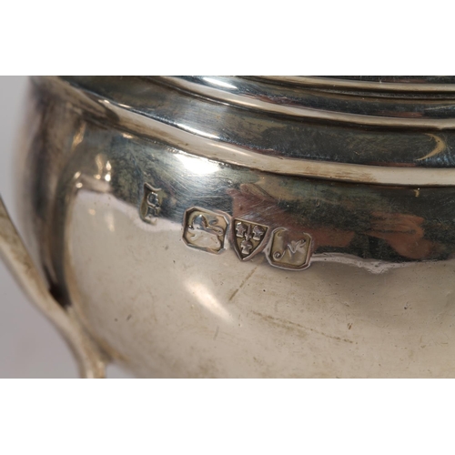 20 - Geo. V silver three piece tea set, the teapot with scrolled ebonised handle, gadrooned rim over a st... 