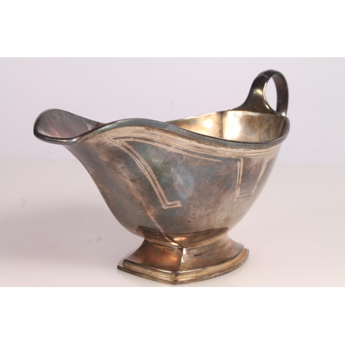 33 - Geo. V Art Deco silver sauce boat, of typical symmetrical form with looped handle and stepped base, ... 