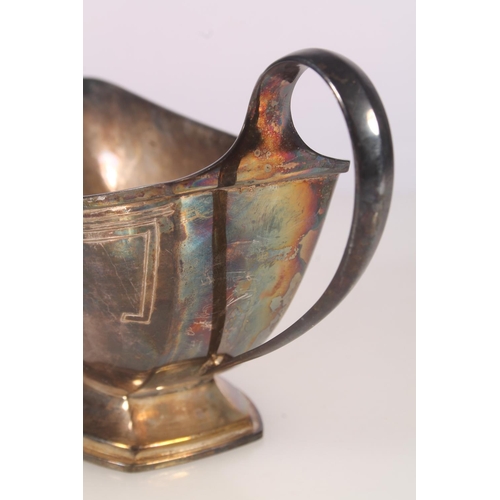 33 - Geo. V Art Deco silver sauce boat, of typical symmetrical form with looped handle and stepped base, ... 