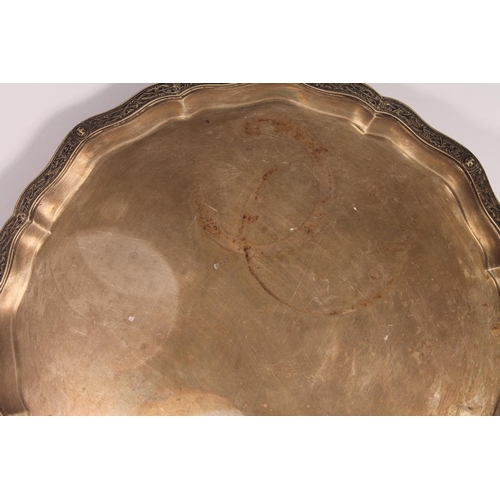 34 - Geo. VI silver salver, the pie crust border with moulded Nordic serpent knotwork, on four ball and c... 