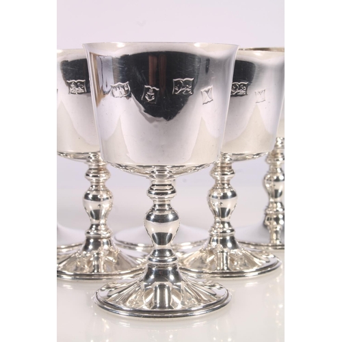35 - Set of six ER.II Mappin and Webb silver goblets, the tapering round bowls with gilt interior, over a... 
