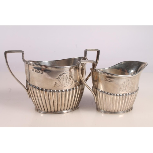 37 - Victorian three piece silver tea set, the half lobed bodies with angular handles, James Deakin and S... 