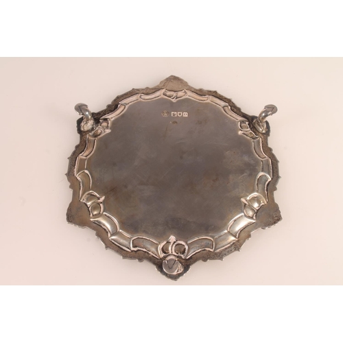 43 - Victorian silver card tray with conch shell and wavy edged border raised on three pad feet, 16cm, Wi... 