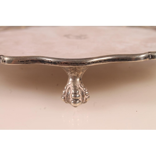 46 - Edwardian silver tray or salver of octagonal form with wavy edged rim, with ball and claw supports, ... 