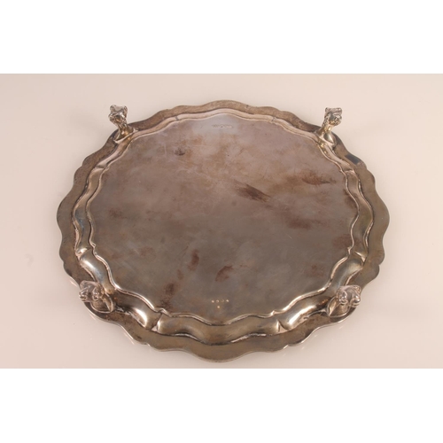 46 - Edwardian silver tray or salver of octagonal form with wavy edged rim, with ball and claw supports, ... 