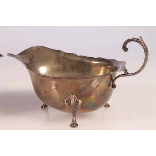 56 - Pair of Geo. V silver sauce boats, with scalloped rim and C scroll handles, Hamilton and Inches Edin... 