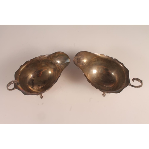 56 - Pair of Geo. V silver sauce boats, with scalloped rim and C scroll handles, Hamilton and Inches Edin... 