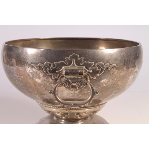 57 - Geo. V silver pedestal fruit bowl, the round bowl with hinged loop handles, tapering to a cast trefo... 