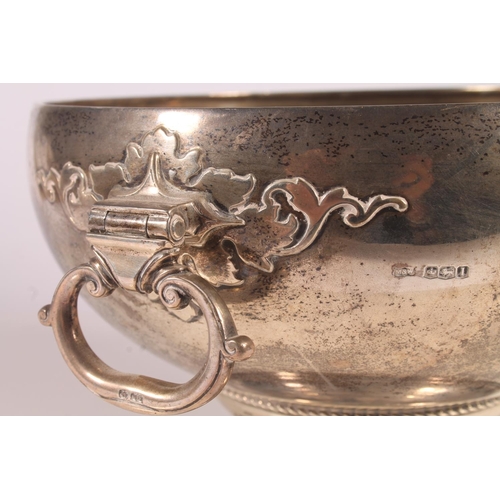 57 - Geo. V silver pedestal fruit bowl, the round bowl with hinged loop handles, tapering to a cast trefo... 