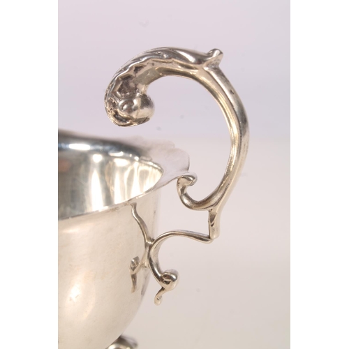 7 - Irish silver cream jug, the body of typical form with scalloped edge, acanthus scroll cast handle an... 