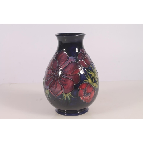 309 - Moorcroft Anenome pattern vase, of baluster form with typical tube-lined floral decoration on a blue... 