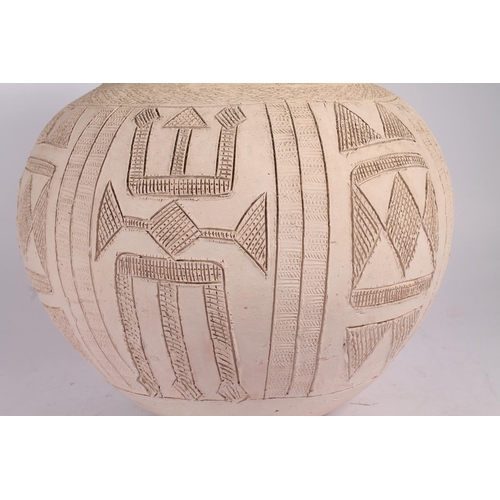 310 - Ladi Kwali (Nigerian 1925-1984); An Abuja biscuit ware studio pottery grain pot, of large proportion... 
