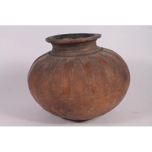 311 - An Abuja pottery water or grain bowl, the unglazed brown clay vessel of round form, the body decorat... 