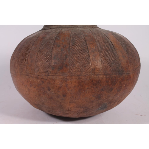 311 - An Abuja pottery water or grain bowl, the unglazed brown clay vessel of round form, the body decorat... 