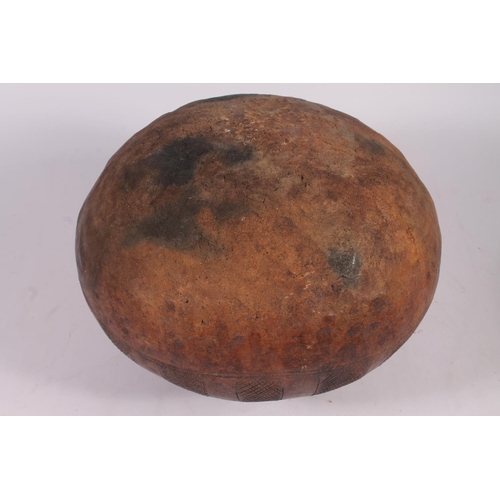 311 - An Abuja pottery water or grain bowl, the unglazed brown clay vessel of round form, the body decorat... 