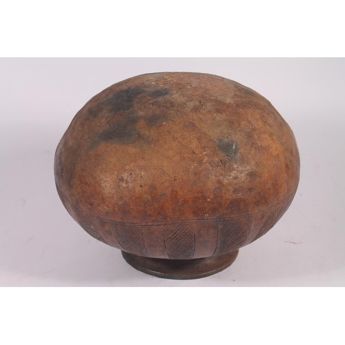 311 - An Abuja pottery water or grain bowl, the unglazed brown clay vessel of round form, the body decorat... 