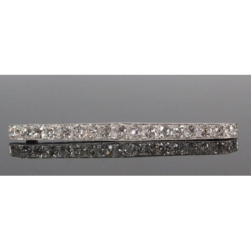 159 - Unhallmarked white metal bar brooch set with a row of seventeen graduated diamonds, 6cm long, approx... 