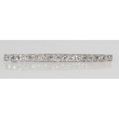 159 - Unhallmarked white metal bar brooch set with a row of seventeen graduated diamonds, 6cm long, approx... 
