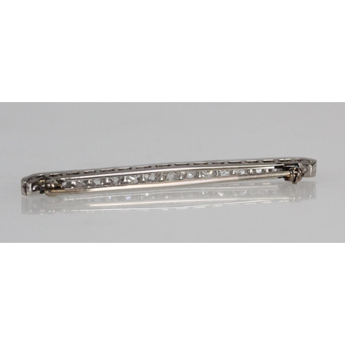 159 - Unhallmarked white metal bar brooch set with a row of seventeen graduated diamonds, 6cm long, approx... 