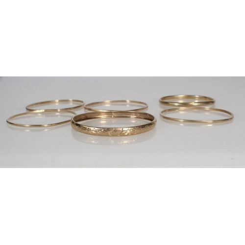 170 - 9ct gold foliate bangle, 5.1g, a 9ct yellow gold bangle, 6.8g and four other yellow metal bangles.