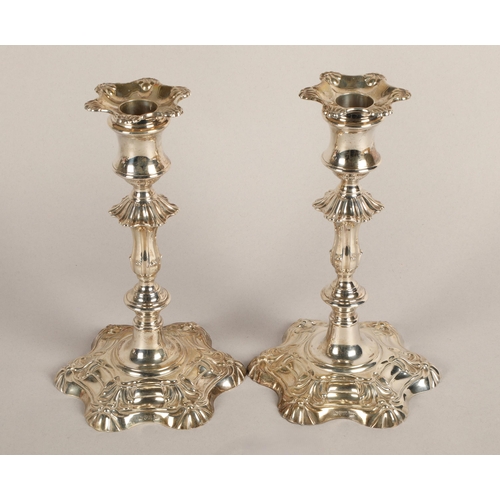 98 - Pair of weighted silver candlesticks, assay marked Chester 1906, maker Walker & Hall22.5cm high... 