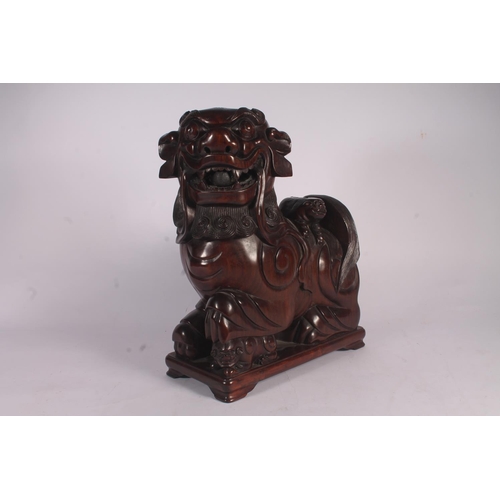 17 - Chinese carved hardwood Qilin or Foo Dog figure, 36cm high.