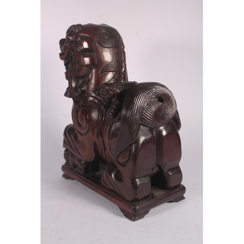 17 - Chinese carved hardwood Qilin or Foo Dog figure, 36cm high.
