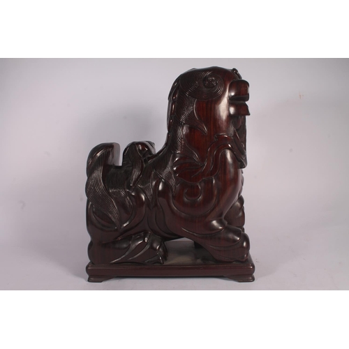 17 - Chinese carved hardwood Qilin or Foo Dog figure, 36cm high.