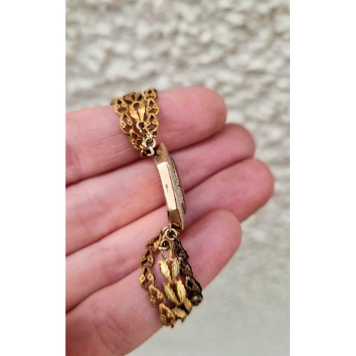 57 - Ladies three strand yellow metal bracelet with enamelled mourning clasp, 10.2g