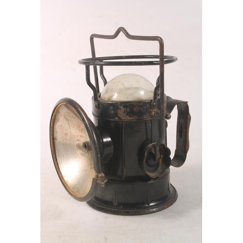 Lucas car lamp and a vintage black metal inspection light.