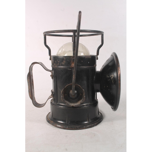 Lucas car lamp and a vintage black metal inspection light.