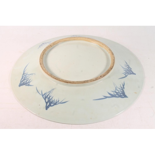 44 - Oriental blue and white porcelain plate decorated with exotic birds amongst foliage, 41cm wide.
