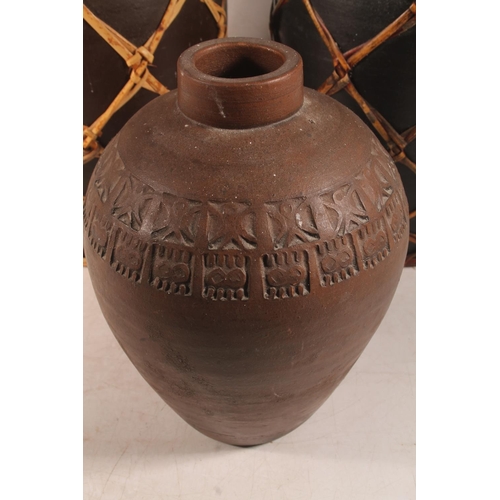 50 - Tribal style pair of pottery grain urns, and a similar vase.
