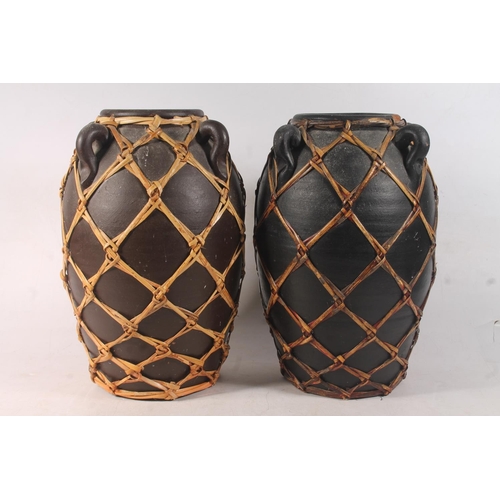 50 - Tribal style pair of pottery grain urns, and a similar vase.