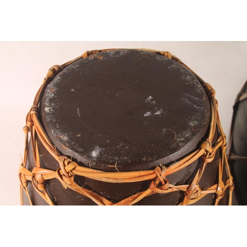 50 - Tribal style pair of pottery grain urns, and a similar vase.