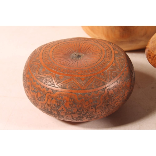 53 - Carved fruitwood bowl, another similar, and an engraved African nut.