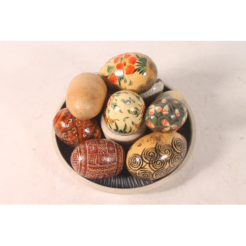 56 - Carved and painted decorative eggs and a Studio Pottery mushroom dish.