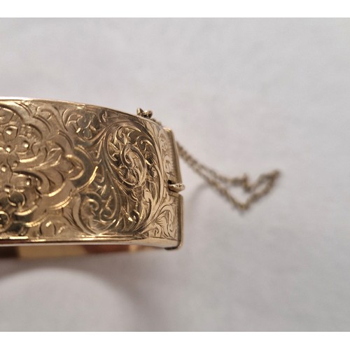 73 - Ladies 9ct yellow gold broad hinged bangle with engraved detail, weight 23.8g