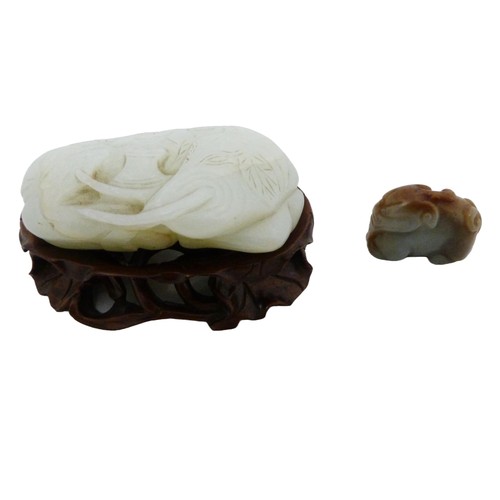 315 - Chinese celadon jade carving of a recumbent kylin, Qing Dynasty, on a padouk stand, 9cm, and another... 